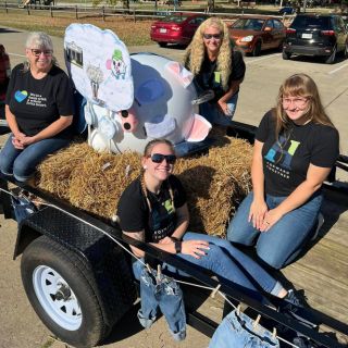 Bankers sitting on an office float during the Albany Independent Fair